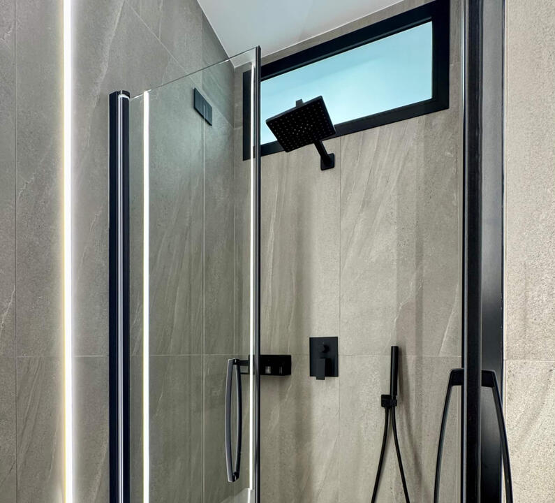 Modern bathroom featuring a sleek walk-in shower and elegant, clean design.