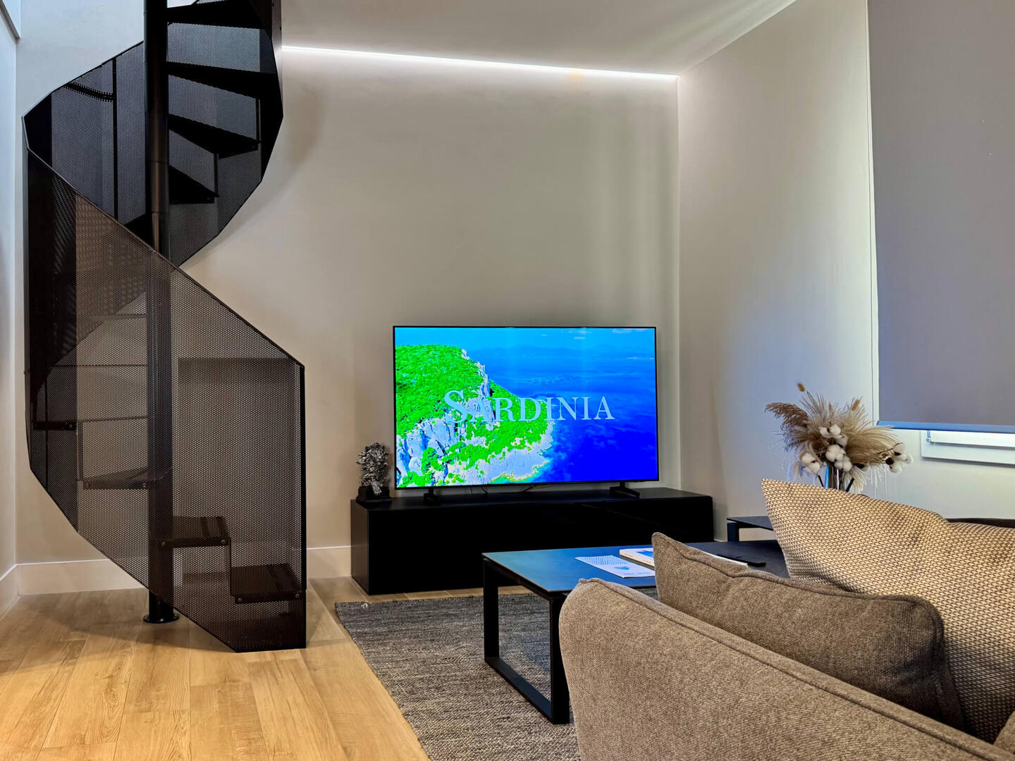 Living Area equipped with a comfy Sofa (bed) and large TV